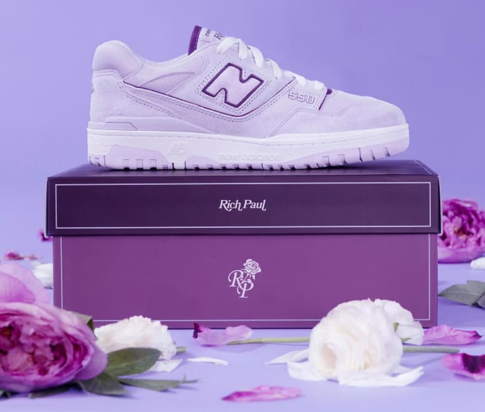 Side view of purple and white New Balance 550 sneakers.